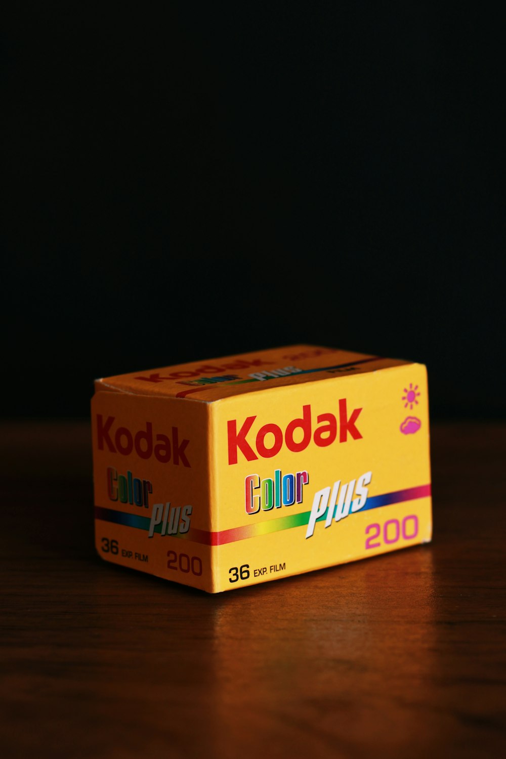 white and purple box on brown wooden table