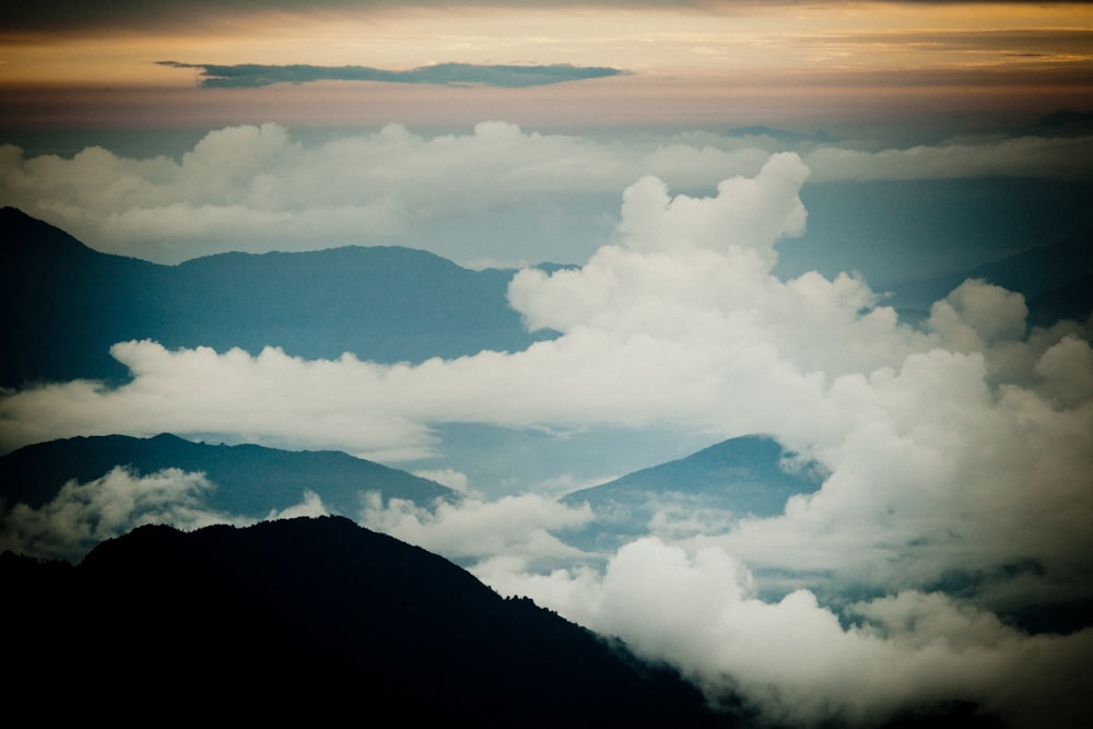 white clouds over mountains during daytime