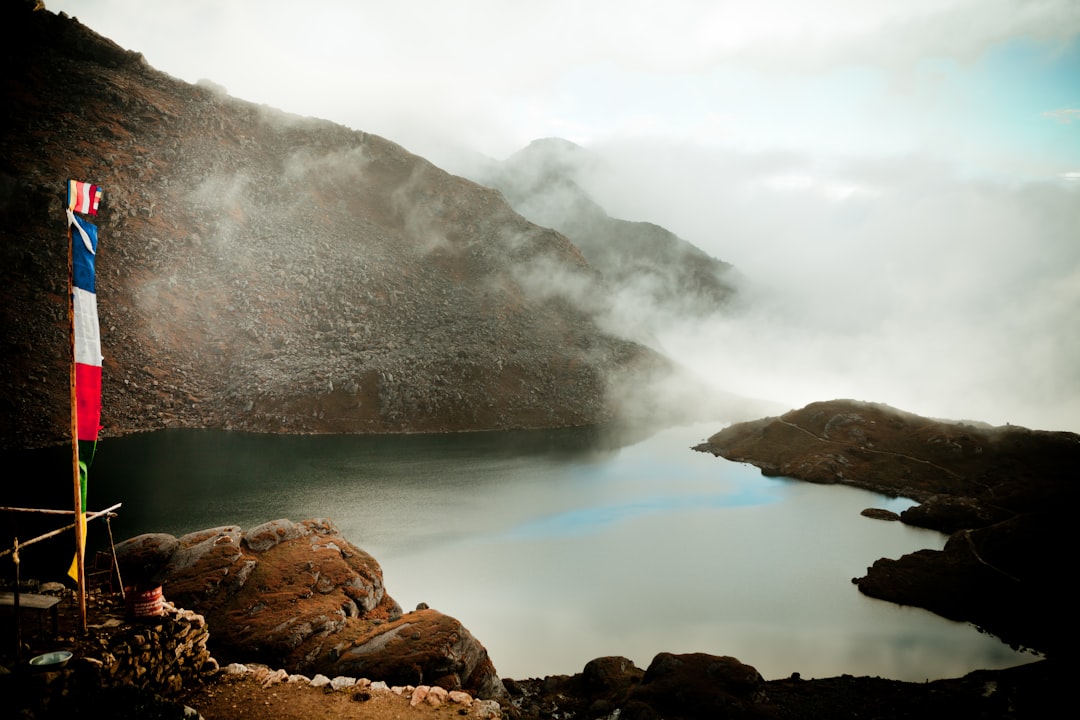 brown rock formation on body of water during daytime