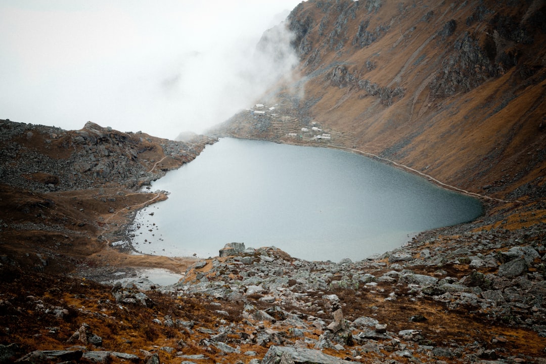 brown rocky mountain with fog