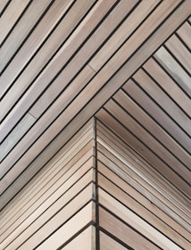 Wooden panels arranged in a geometric pattern with clean lines and a corner meeting at an angle.