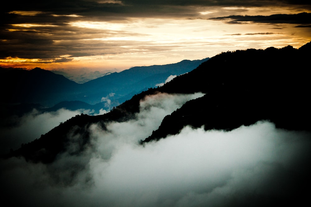 mountains covered with clouds during daytime