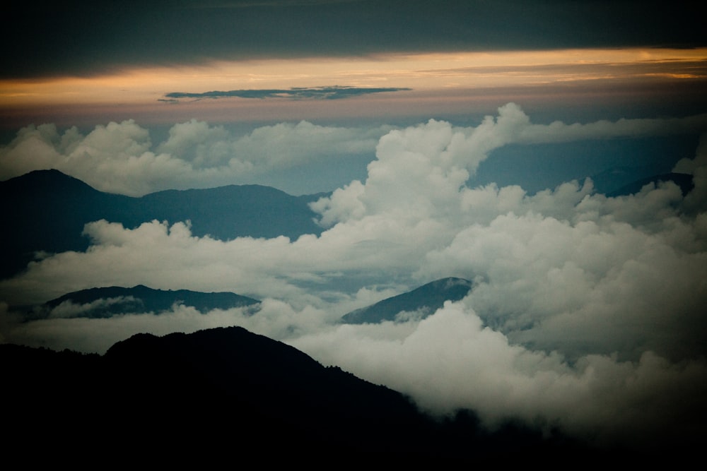 white clouds over mountains during daytime