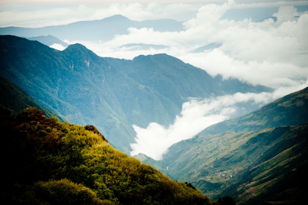 green and brown mountains under white clouds during daytime