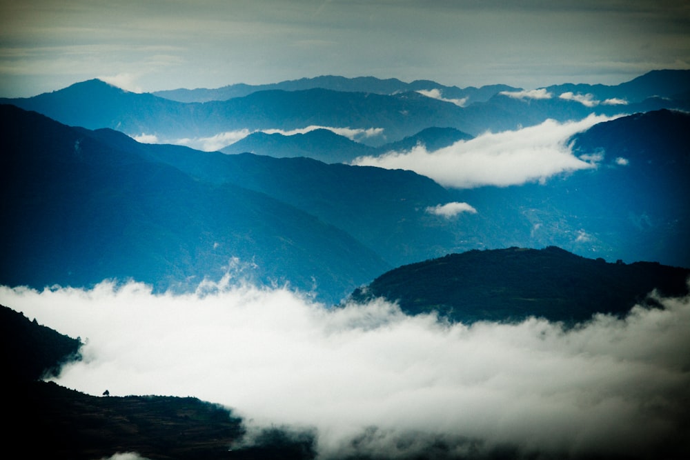 mountains under white clouds during daytime