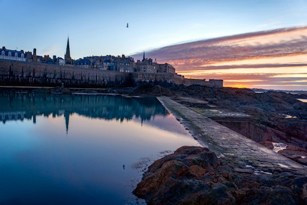 The walled city reflected at sunrise — Saint-Malo, France