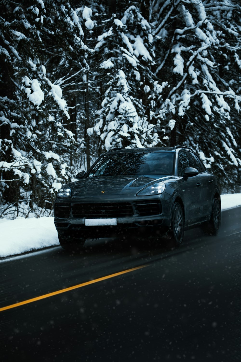 black car on road during winter
