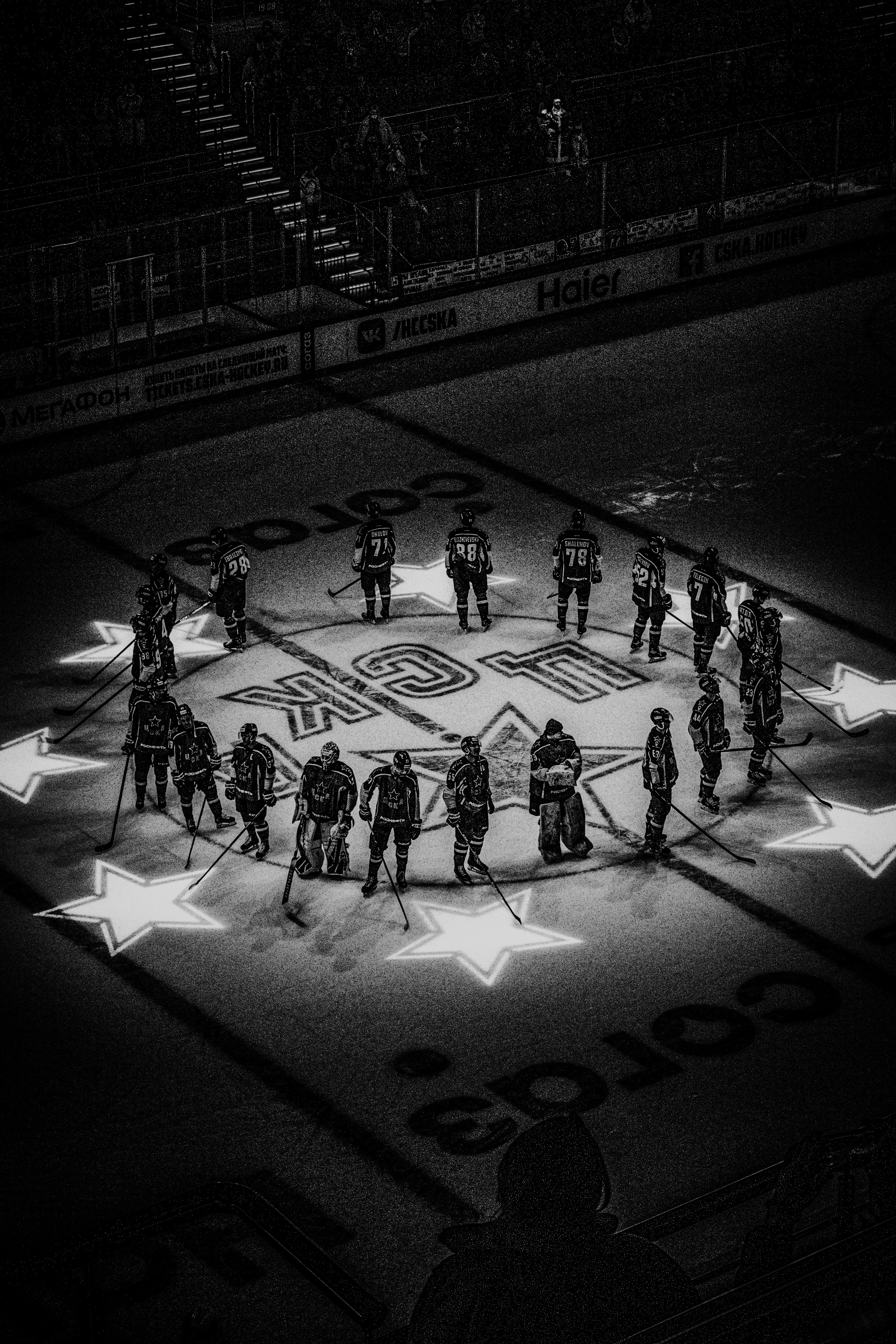 grayscale photo of people playing basketball