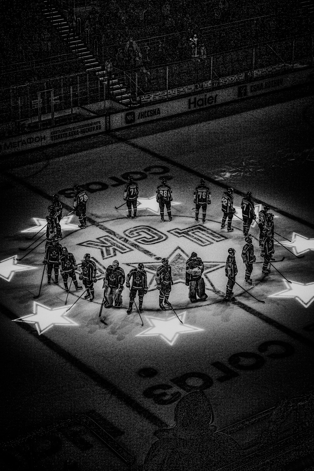 grayscale photo of people playing basketball