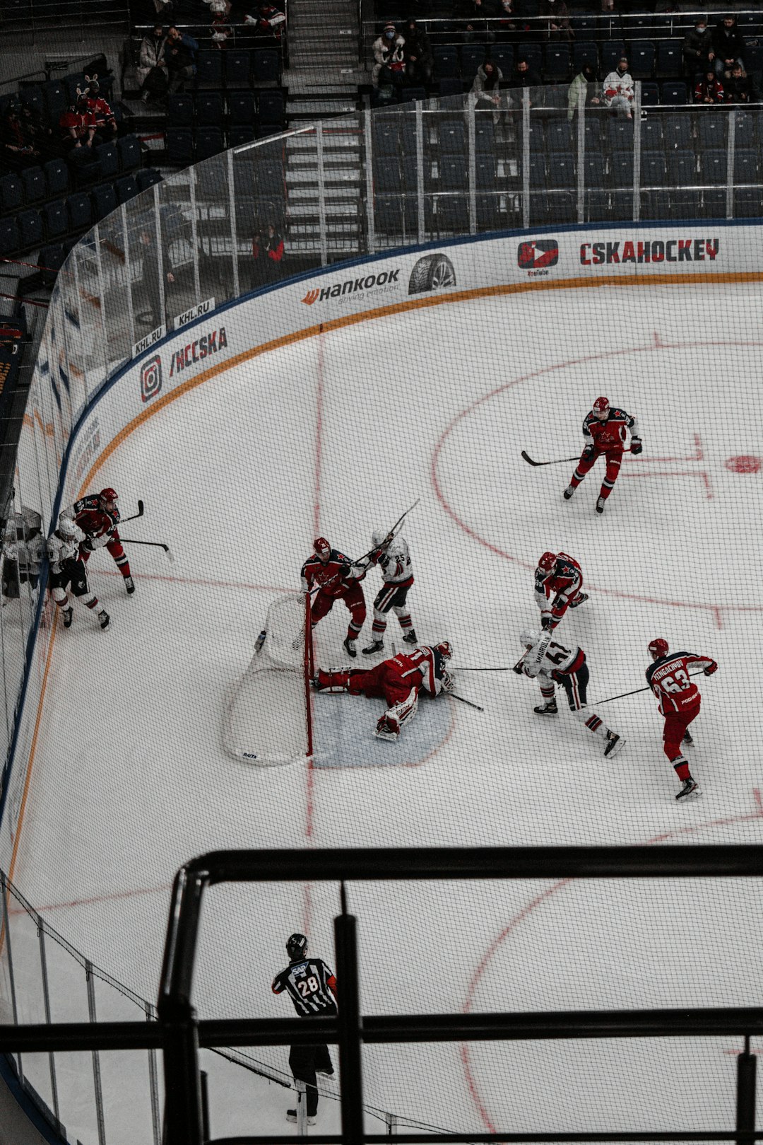 people riding on red and white ice hockey stadium