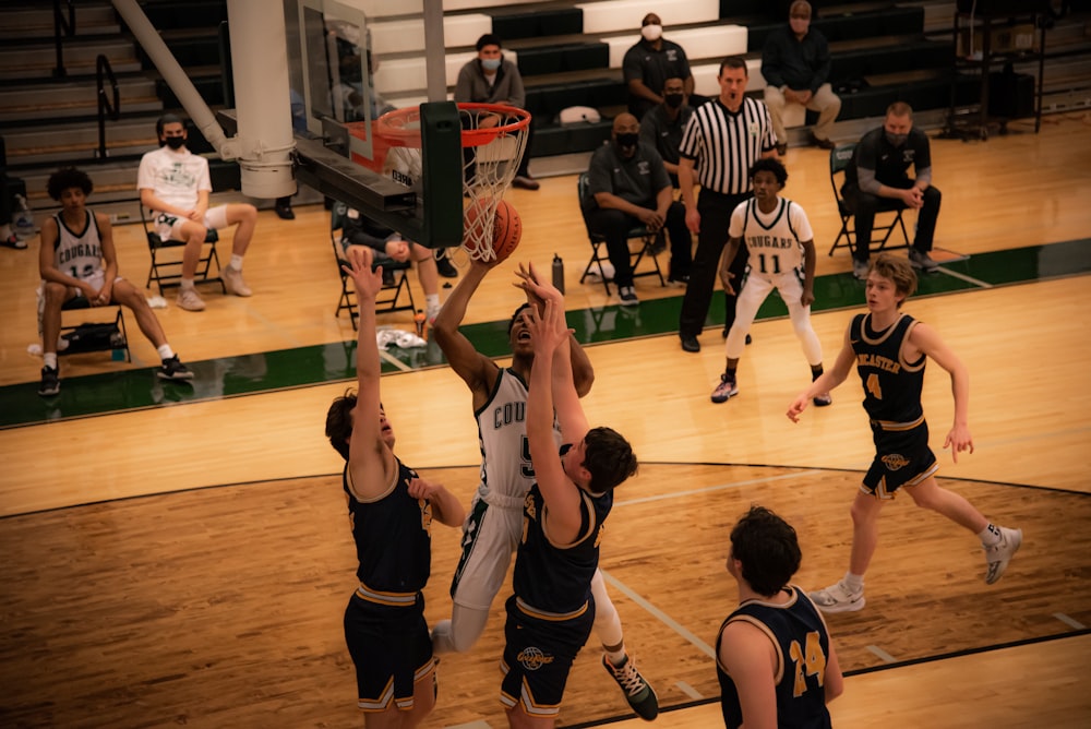 basketball players playing on basketball court