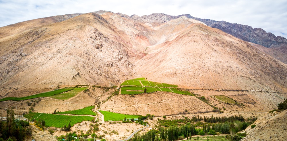 Campo de hierba verde cerca de la montaña durante el día