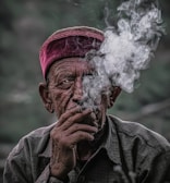 man in gray jacket smoking
