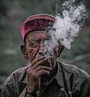 man in gray jacket smoking