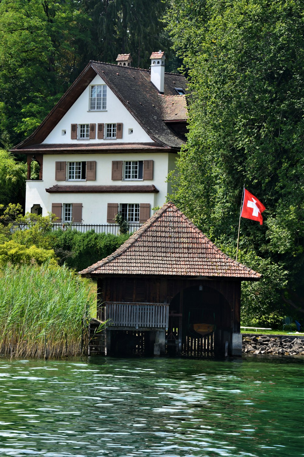 Weißes und braunes Haus am Fluss tagsüber