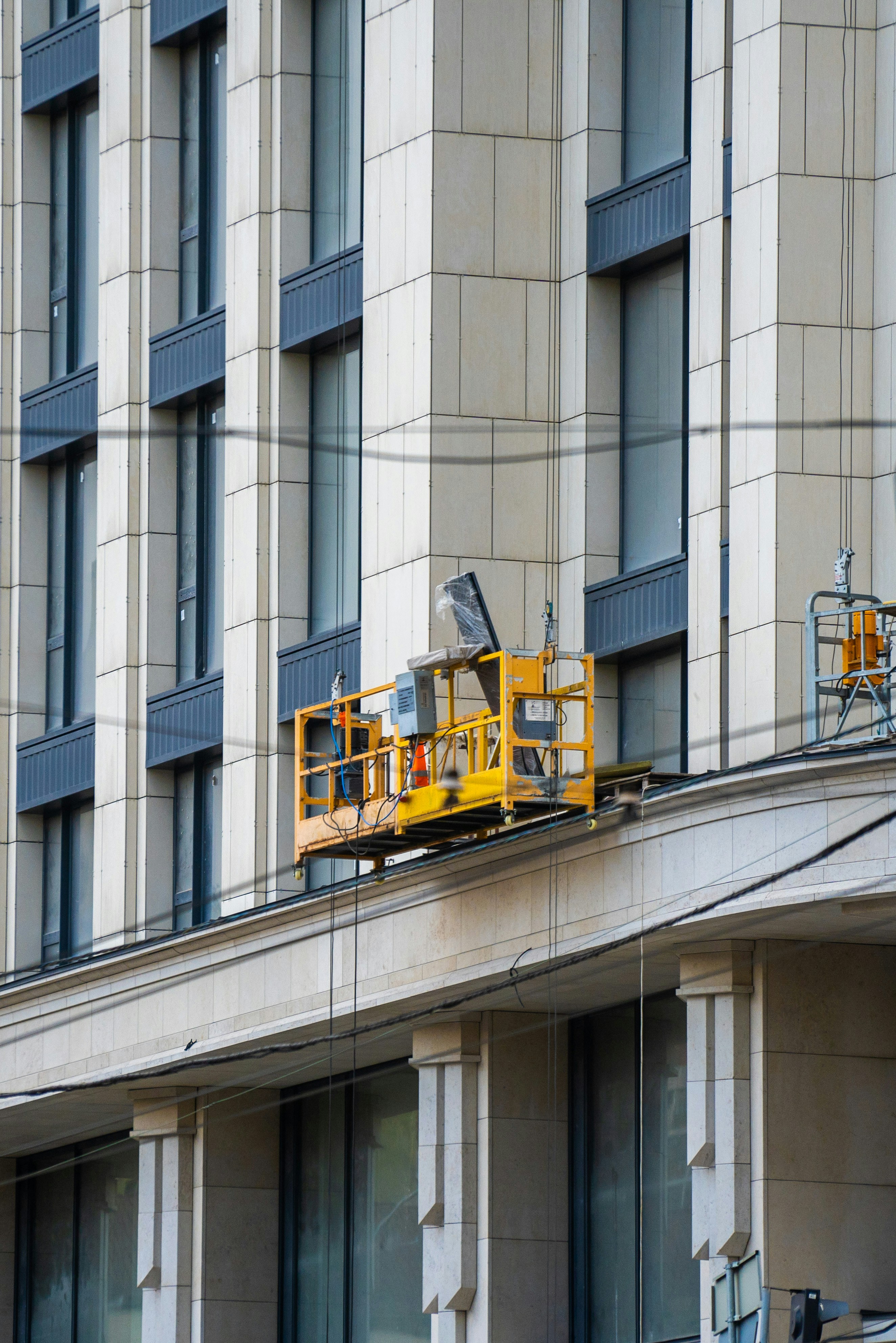 yellow and black train on gray concrete building during daytime