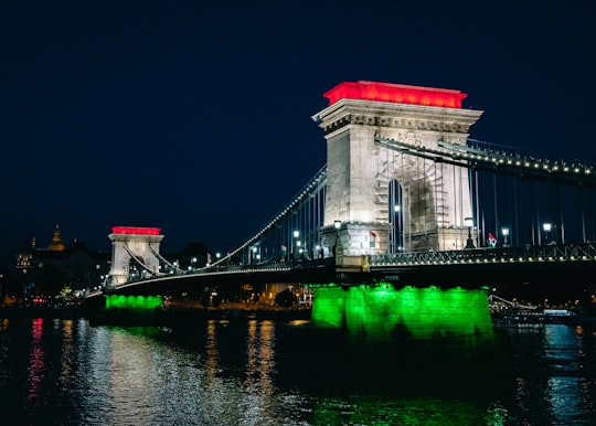white concrete bridge during night time in Széchenyi Chain Bridge Hungary