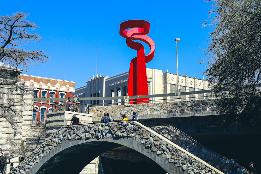 people walking on gray concrete bridge during daytime