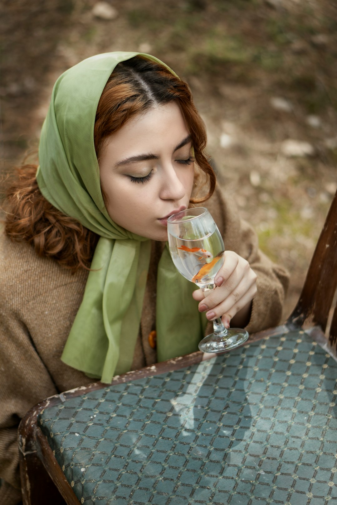 woman in green hijab holding clear wine glass