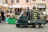 A wide shot of our delivery truck parked in front of a bustling local market.