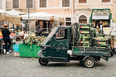 Delivery truck unloading fresh food crates at a Buenos Aires market.