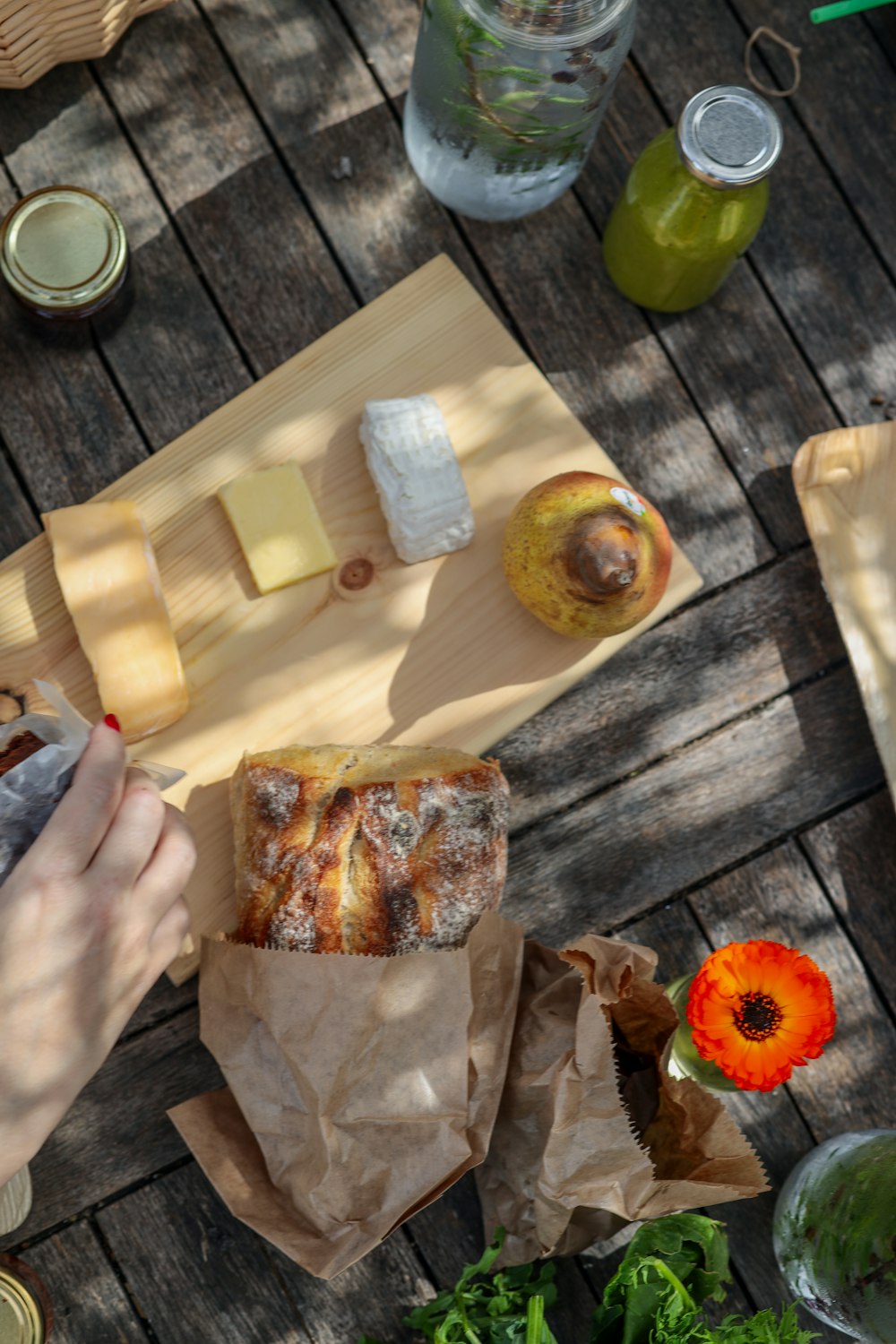 bread with sliced tomato and sliced of bread on brown wooden chopping board