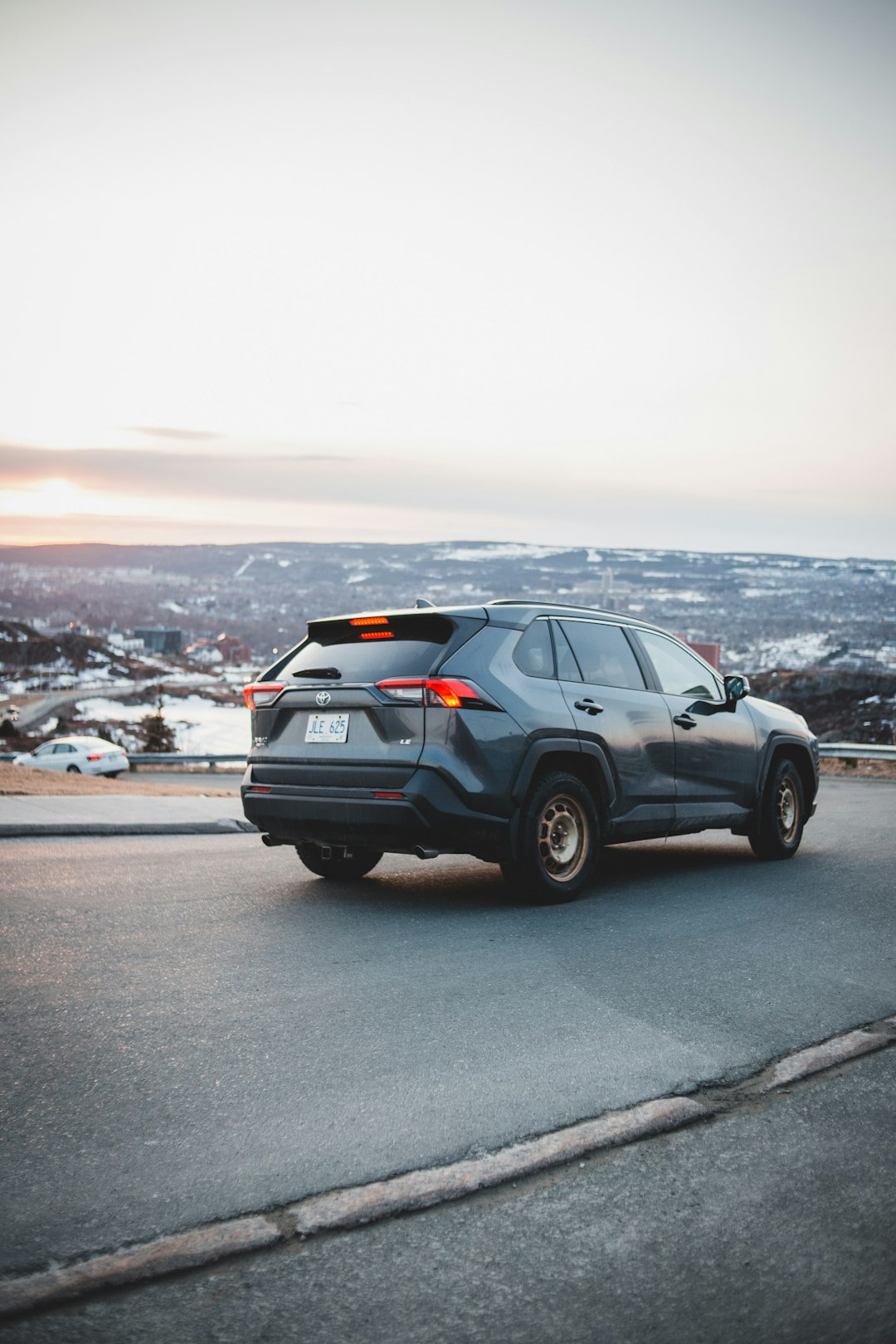 black suv on gray asphalt road during daytime