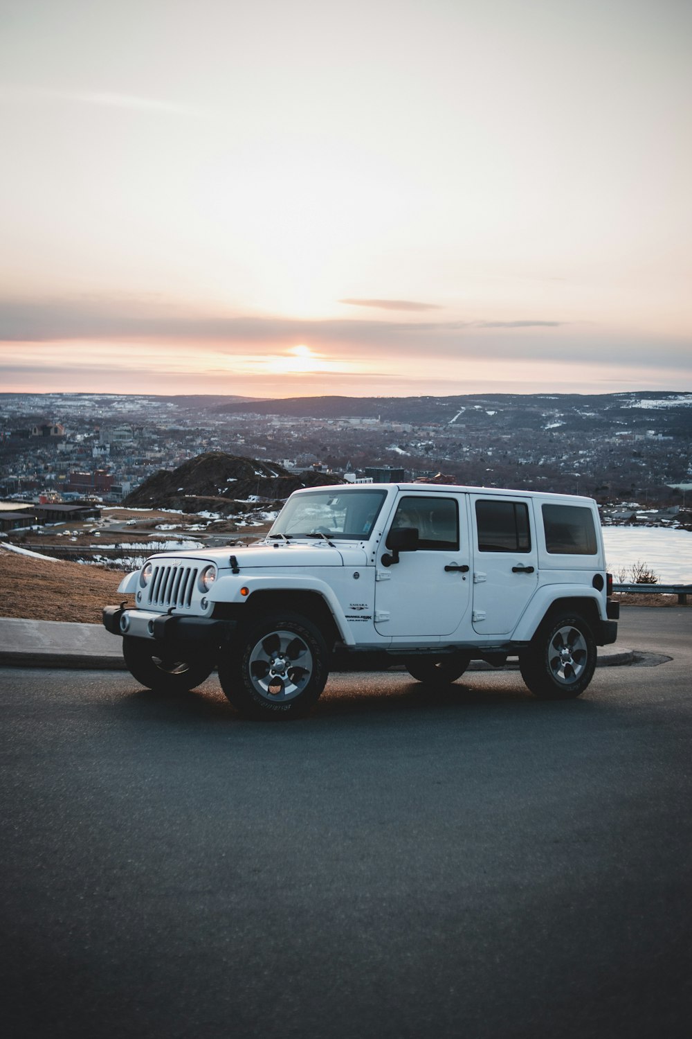 white jeep wrangler on brown dirt road during daytime