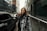A stylish young woman wearing trendy clothing with a vibrant urban backdrop.