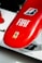 a close up of a red surfboard on a white surface