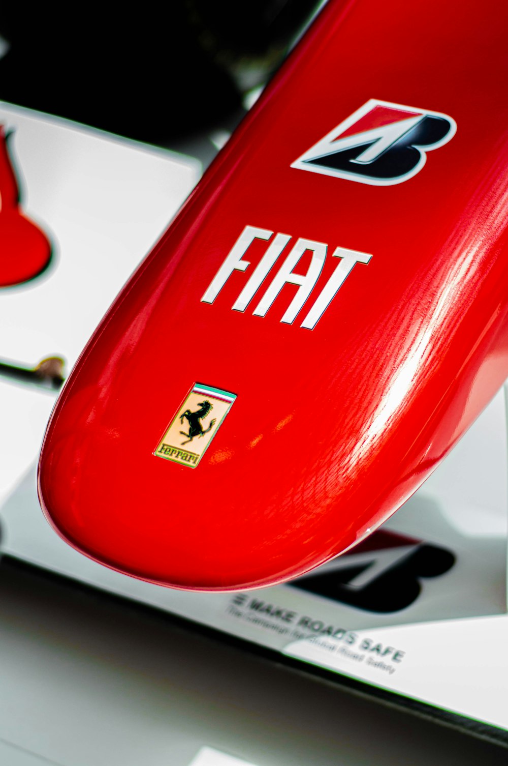 a close up of a red surfboard on a white surface