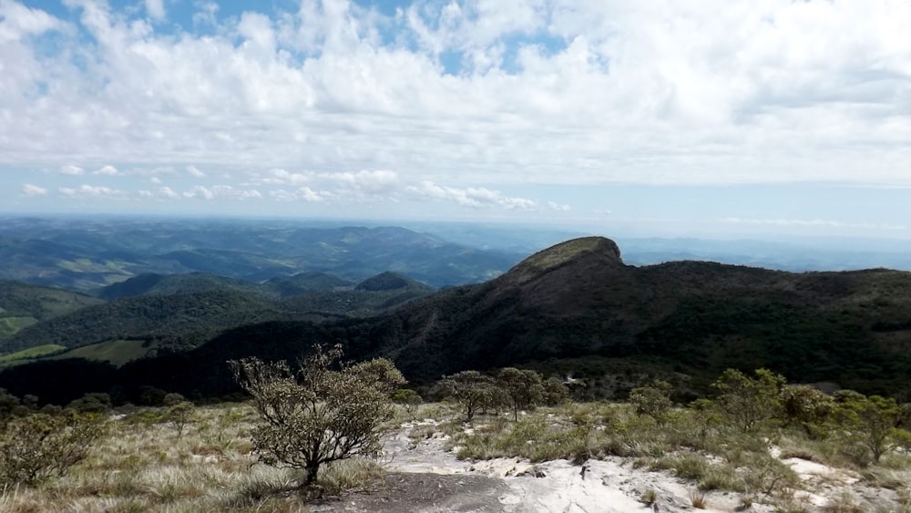 green mountain under white clouds during daytime