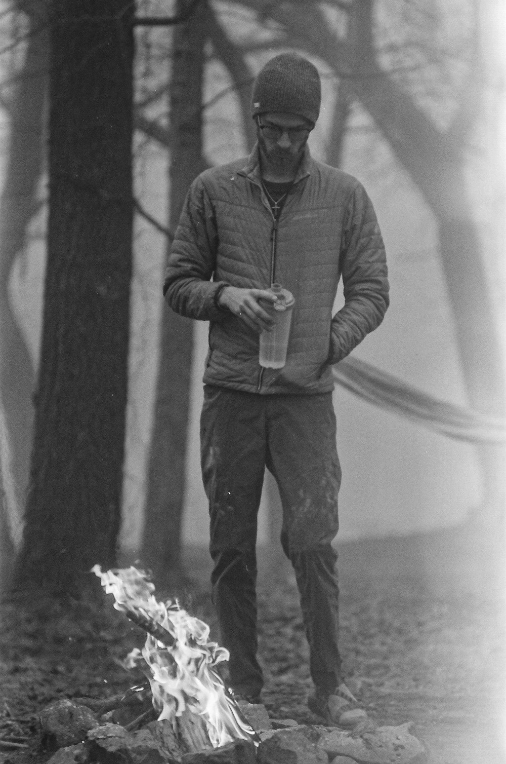 man in gray long sleeve shirt and pants standing beside tree