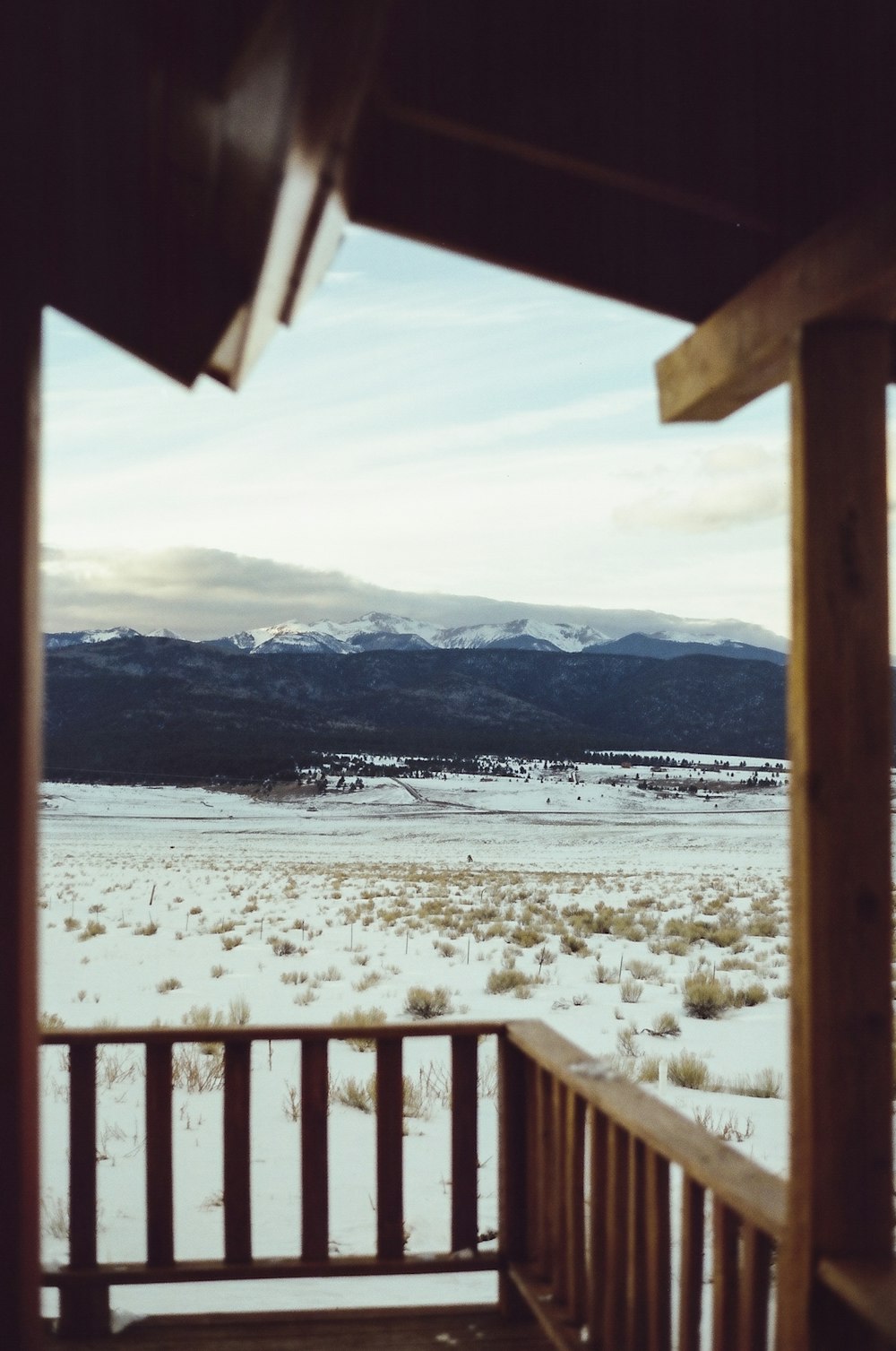 white snow covered ground near body of water during daytime