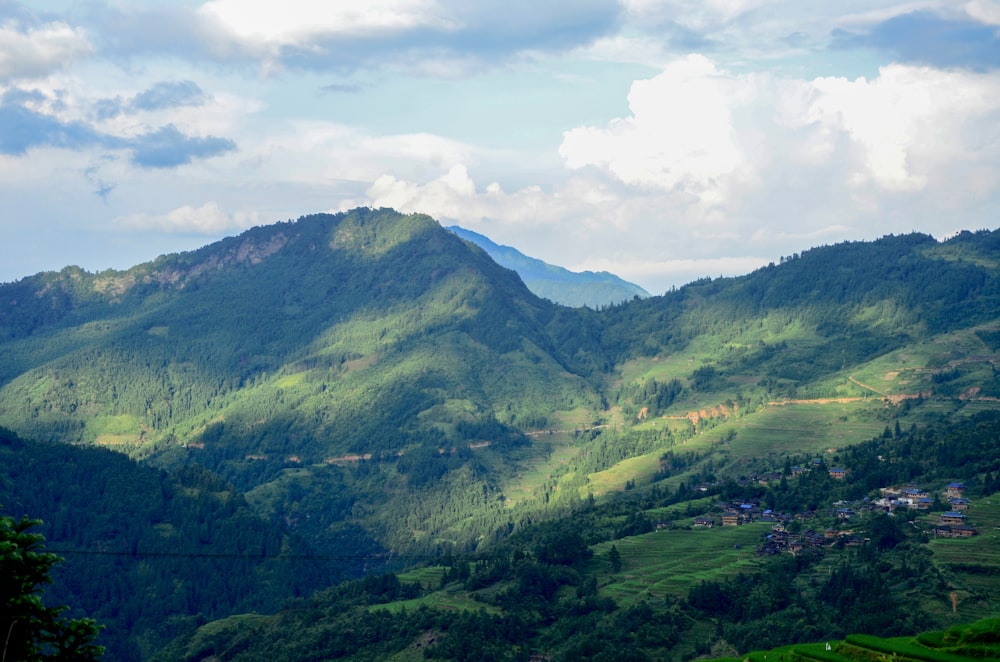 green mountains under white clouds during daytime