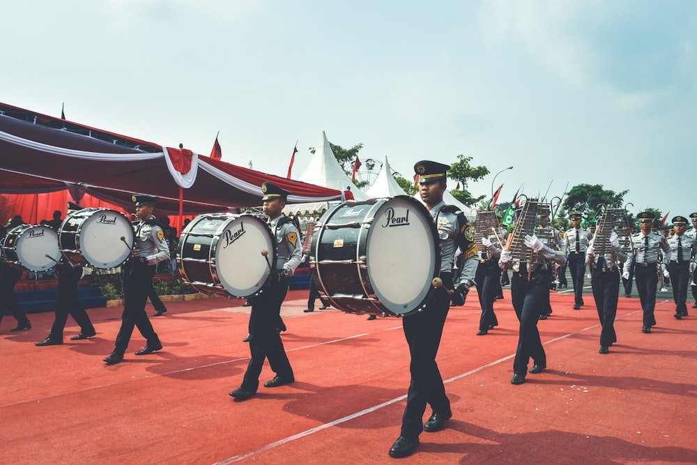 people playing drum on orange concrete floor during daytime