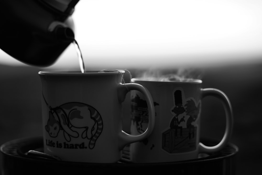 grayscale photo of ceramic mug with spoon