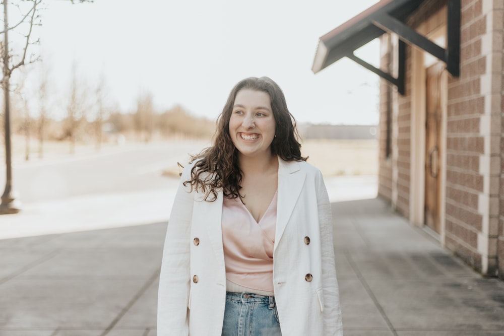 woman in beige coat and blue denim jeans