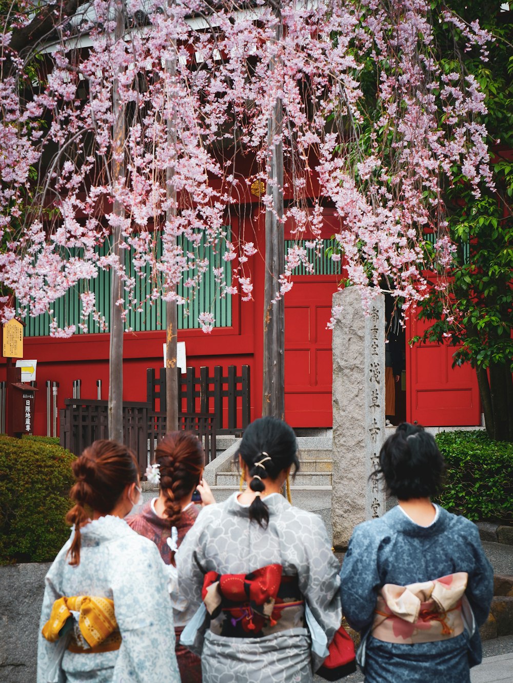 people standing near red concrete building during daytime