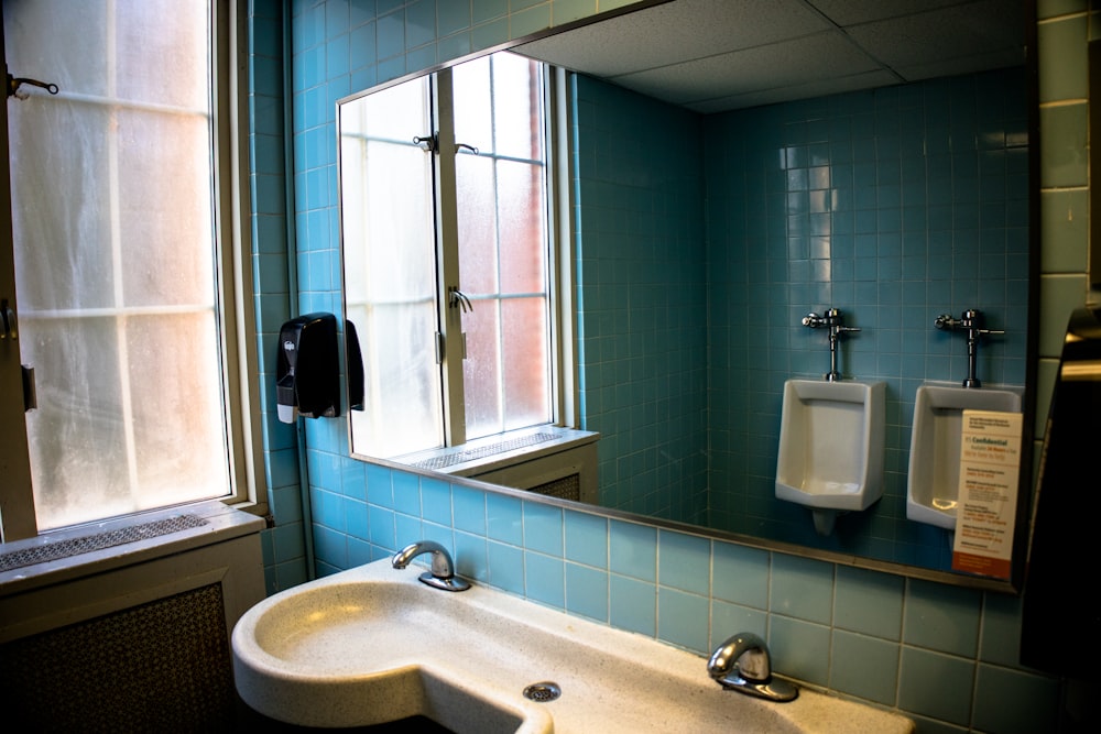 white ceramic sink near window