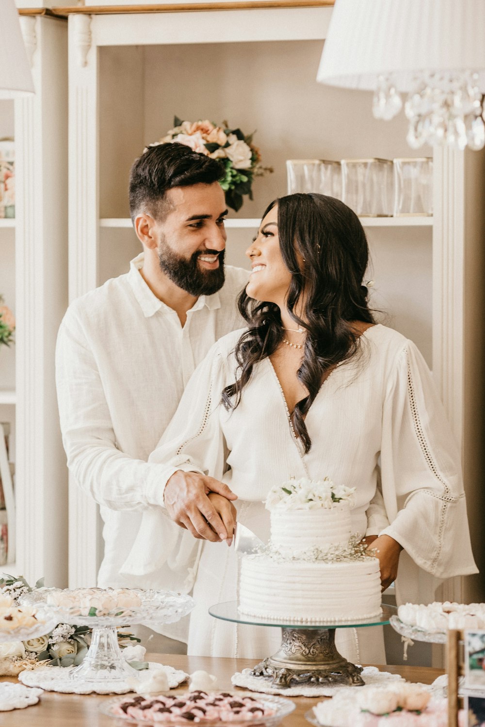 man in white dress shirt kissing woman in white dress