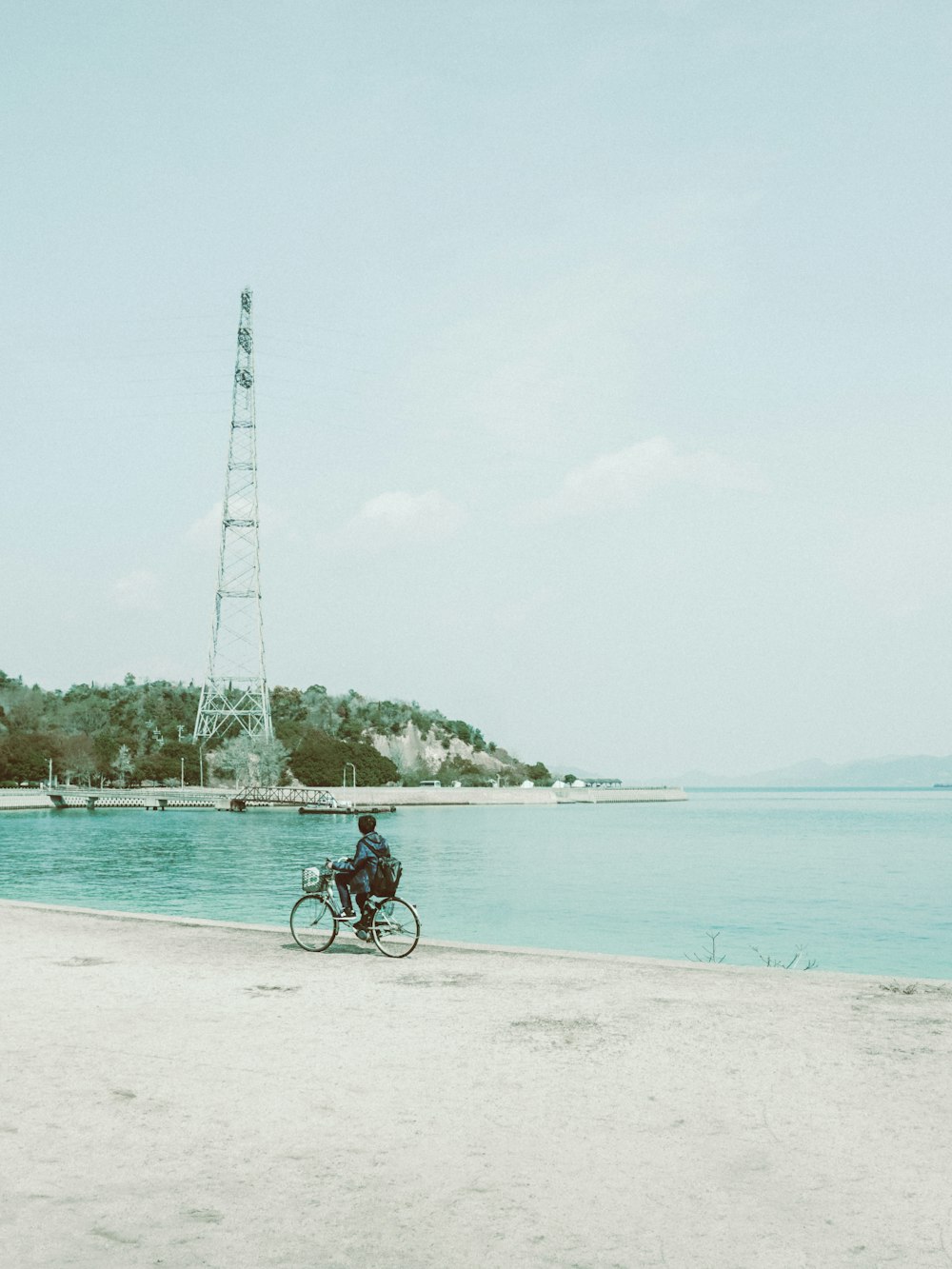 man riding bicycle on beach during daytime