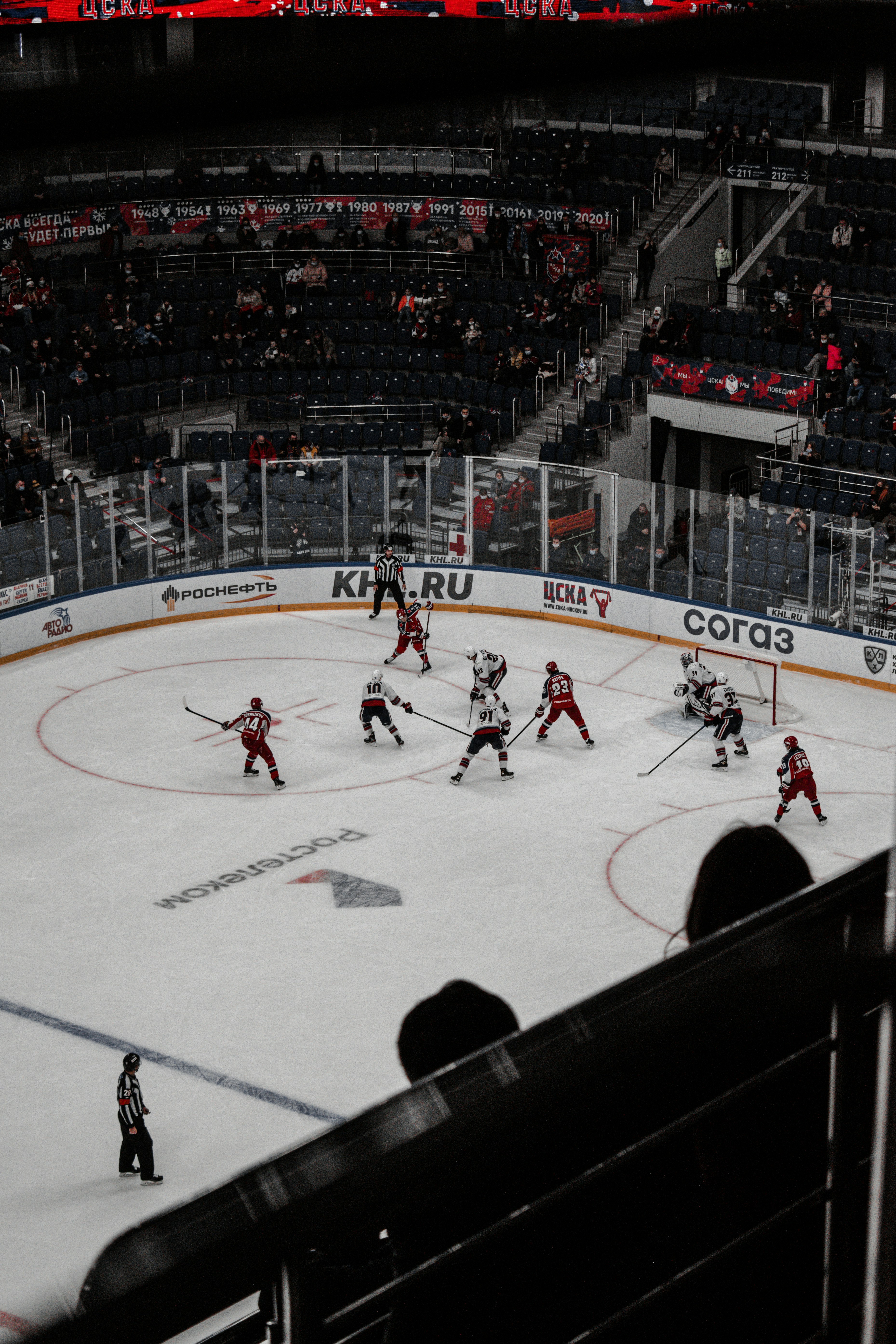 people playing ice hockey inside stadium