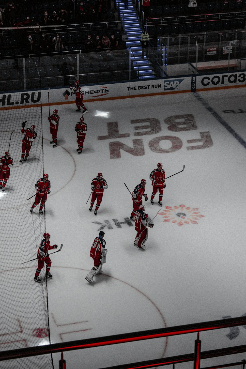 men in red jersey shirt playing ice hockey