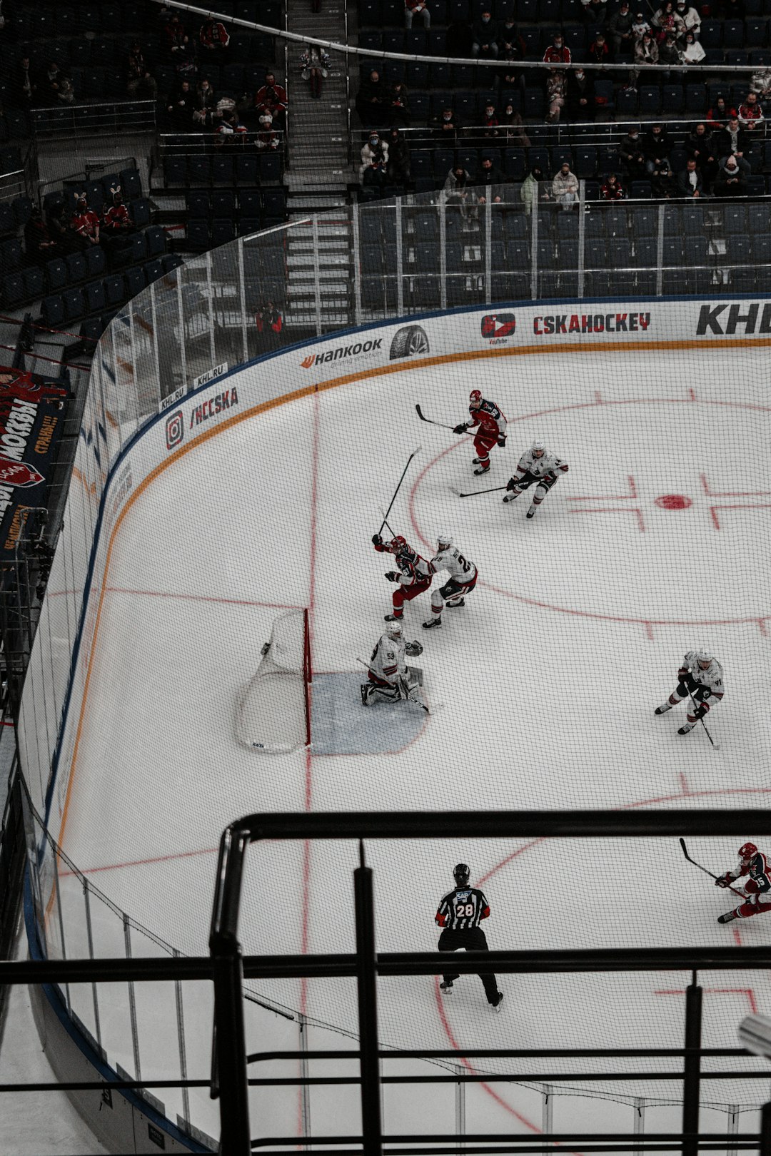 people playing ice hockey on ice field