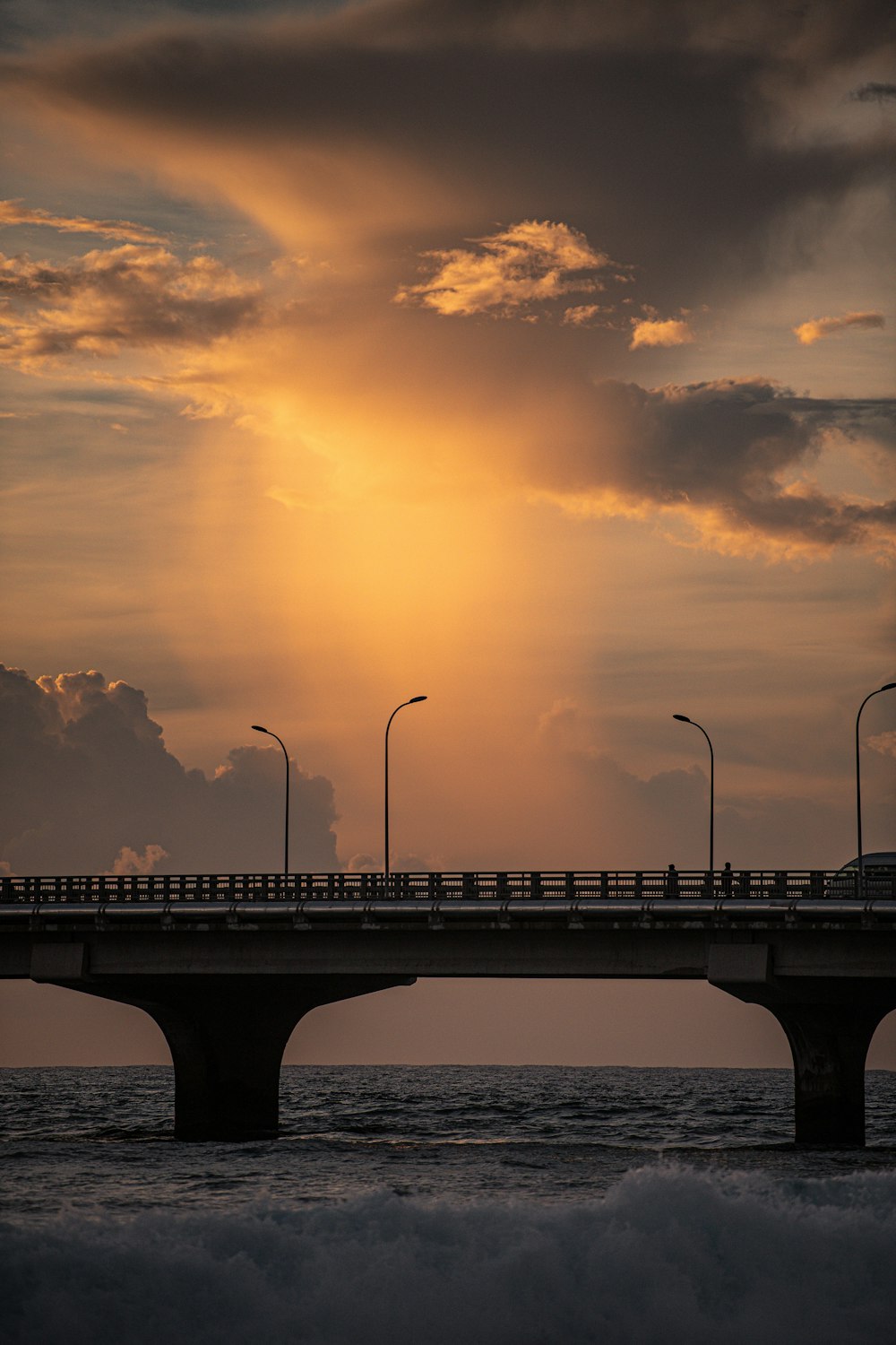 bridge over the sea during sunset