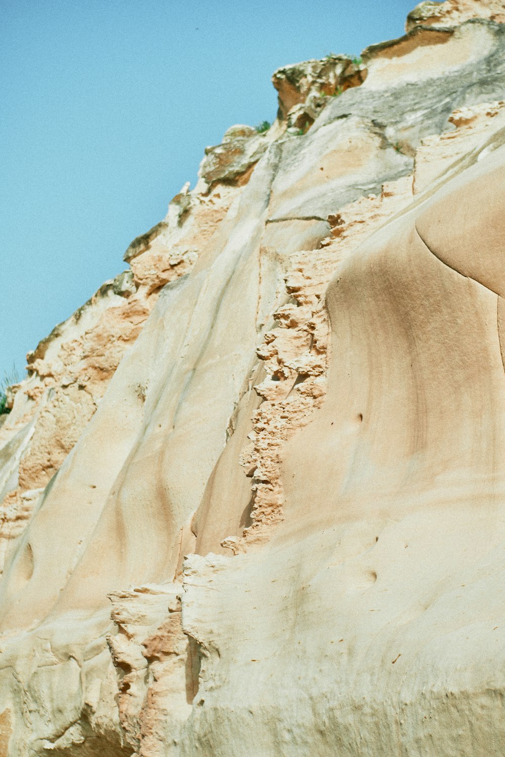 brown rock formation under blue sky during daytime