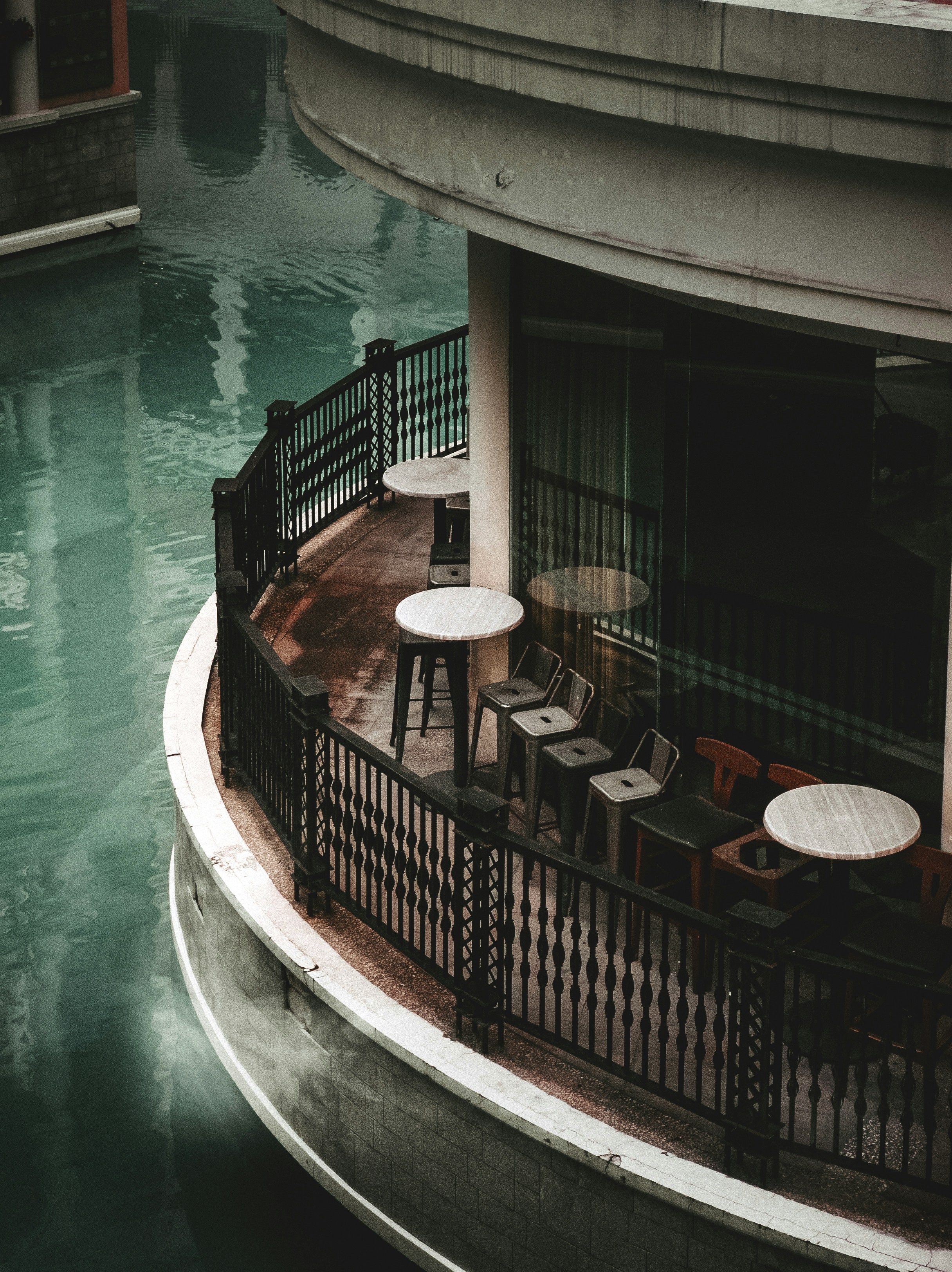 brown wooden round table near body of water during daytime