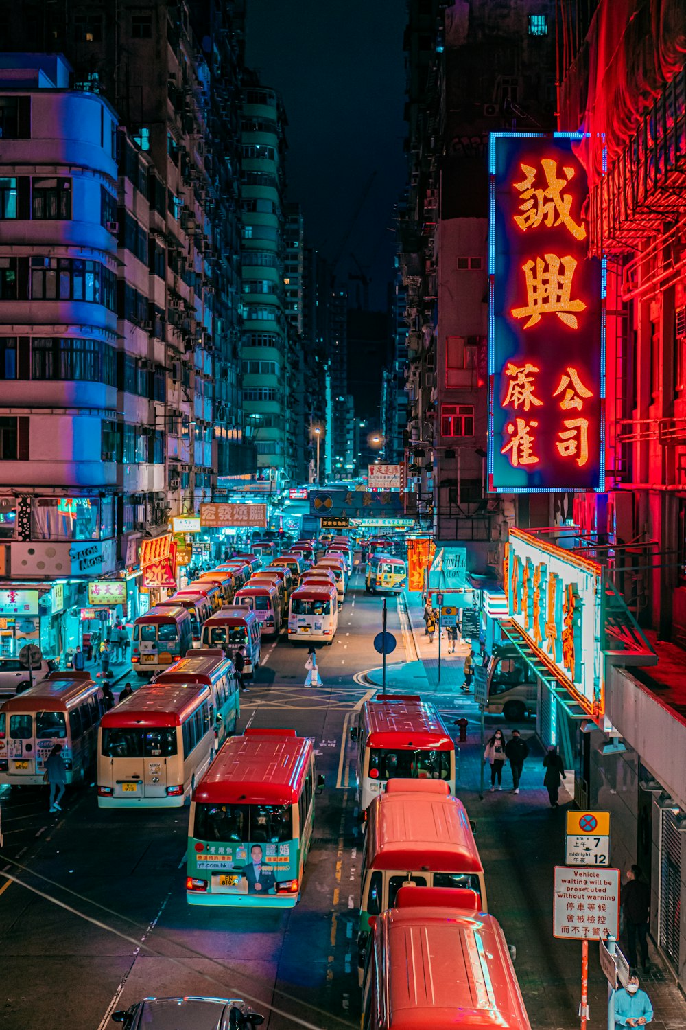 red bus on road during night time