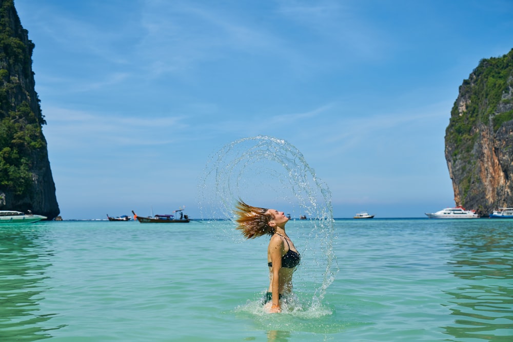 woman in blue bikini on water during daytime